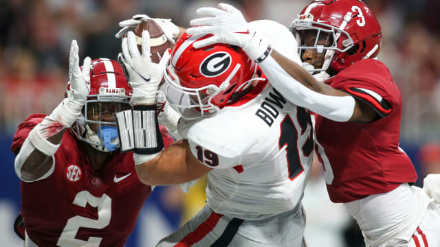 Dec 4, 2021; Atlanta, GA, USA; Georgia Bulldogs tight end Brock Bowers (19) has a reception broken up by Alabama Crimson Tide defensive back DeMarcco Hellams (2) and defensive back Daniel Wright (3) in the second half during the SEC championship game at Mercedes-Benz Stadium.